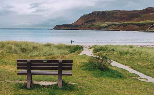 The lovely beach at Calgary Bay, Mull. Two people on the beach admiring the views.