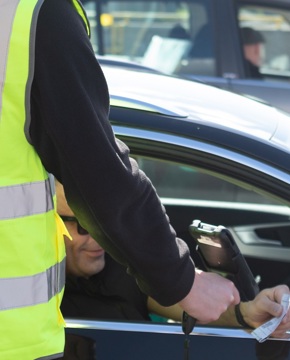 Member of CalMac staff scans customer ticket