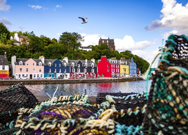 The colourful houses at Tobermory harbour on the Isle of Mull, with fishermens creels in the foreground.