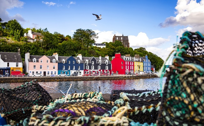 The colourful houses at Tobermory harbour on the Isle of Mull, with fishermens creels in the foreground.