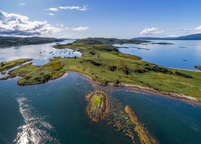 An aerial view of the isle of Kerrera including the Hutcheson monument and the Marina