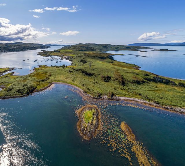 An aerial view of the isle of Kerrera including the Hutcheson monument and the Marina
