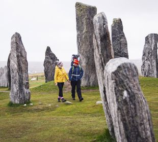 A family walking through the Calanais Standing Stones, Lewis