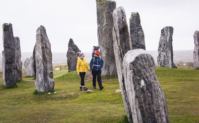 A family walking through the Calanais Standing Stones, Lewis