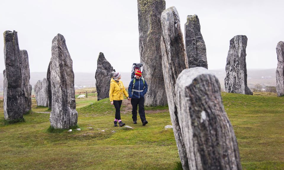 A family walking through the Calanais Standing Stones, Lewis