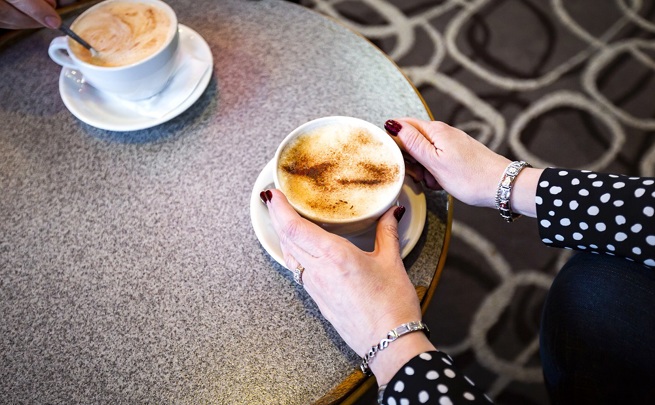 woman holding cup of coffee