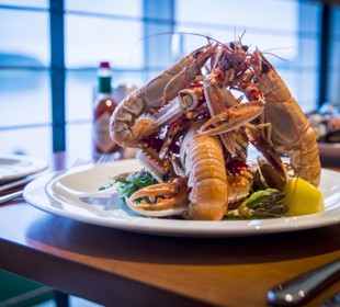 Shrimps on a plate in the restaurant piled high