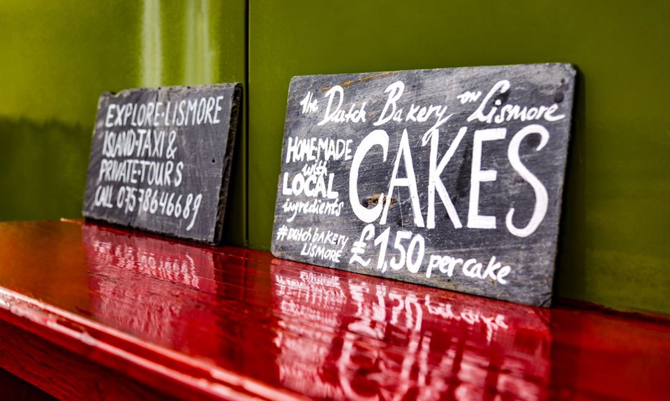 A homemade, chalk board sign for a local bakery selling cakes, Lismore.