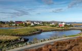 A view of the houses in the village of Lochmaddy, across inland lochs, North Uist.