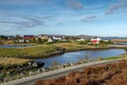 A view of the houses in the village of Lochmaddy, across inland lochs, North Uist.