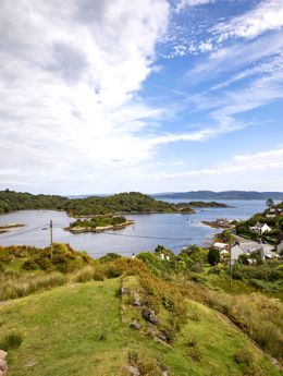 A hilltop view looking towards Tarbert in Kintyre, white houses and across the water.