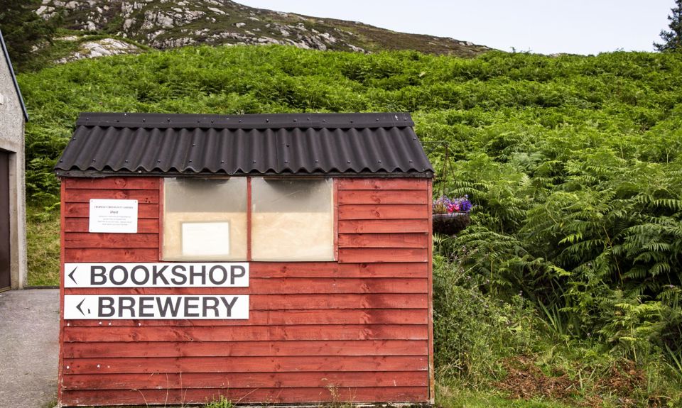 A wooden hut with signage point to the Bookshop and Brewery