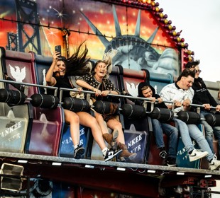 festivalgoers enjoying a fairground ride