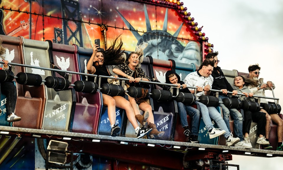 festivalgoers enjoying a fairground ride