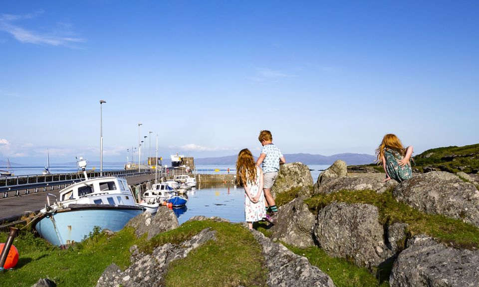 Children exploring the harbourside of Colonsay on a summer day