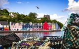 The colourful houses at Tobermory harbour on the Isle of Mull, with fishermens creels in the foreground.