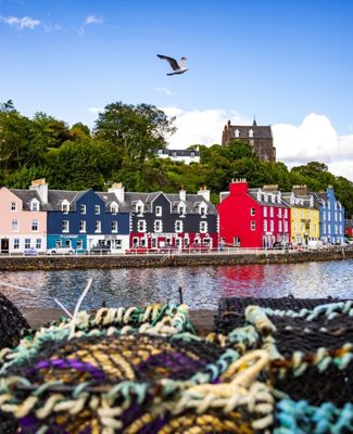 The colourful houses at Tobermory harbour on the Isle of Mull, with fishermens creels in the foreground.