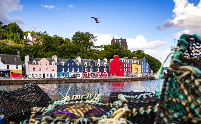 The colourful houses at Tobermory harbour on the Isle of Mull, with fishermens creels in the foreground.