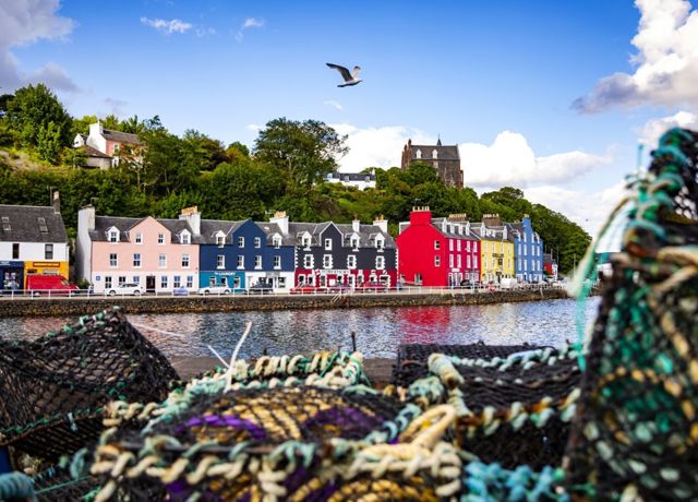The colourful houses at Tobermory harbour on the Isle of Mull, with fishermens creels in the foreground.