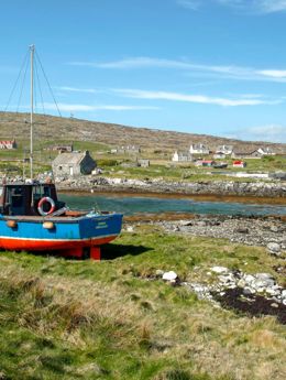 Isle of Berneray - A village with a ship in the foreground