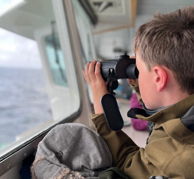 Carbost Primary pupil using binoculars