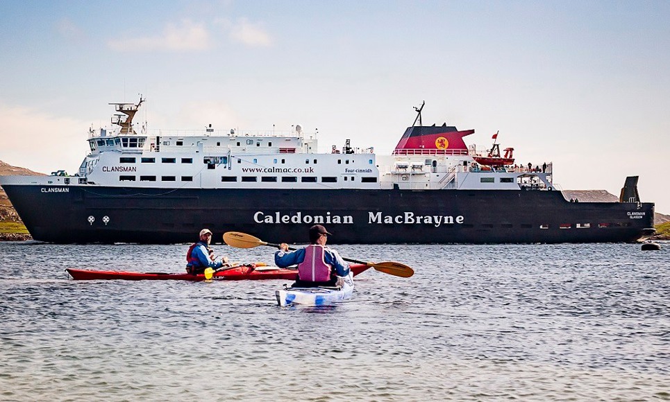 Kayakers next to MV Clansman