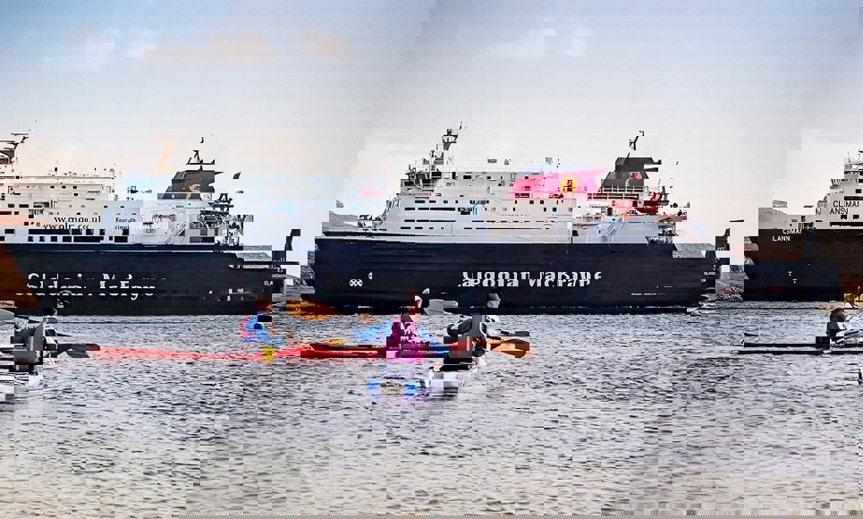 Kayakers next to MV Clansman