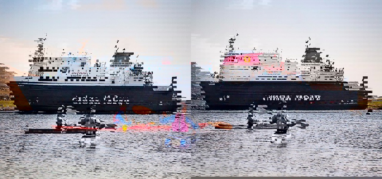 Kayakers next to MV Clansman