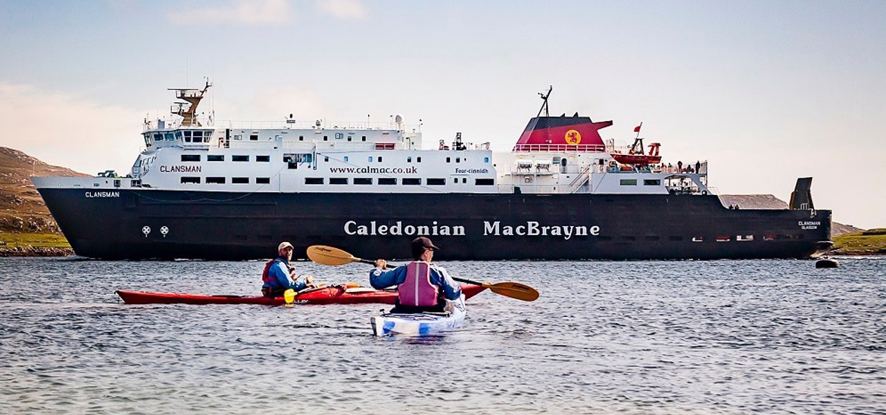 Kayakers next to MV Clansman