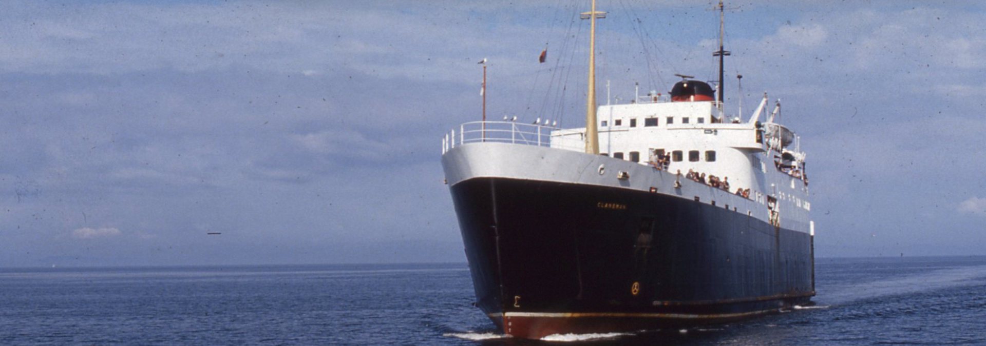 Vintage photo of the Clansman vessel sailing on the water with bow to the front and passengers out on deck.
