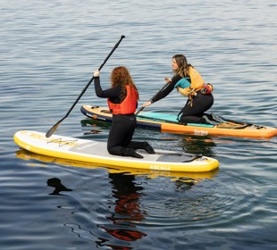 Nati Galloway paddleboarding with another female