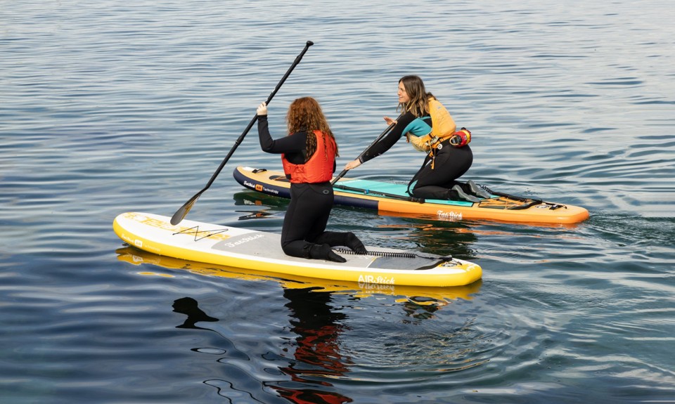 Nati Galloway paddleboarding with another female