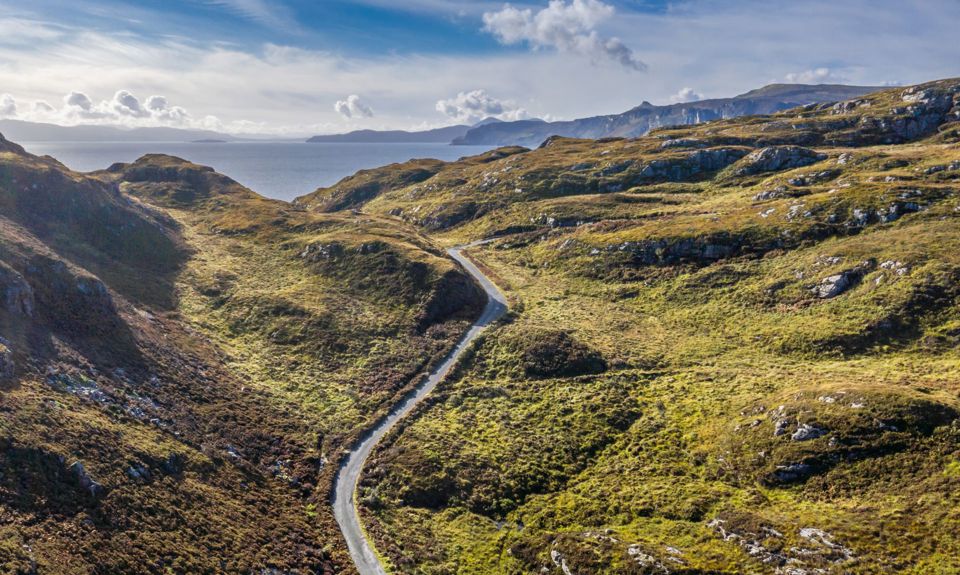 An aerial view of Calums road winding its way up the hilly landscap3 of Raasay.