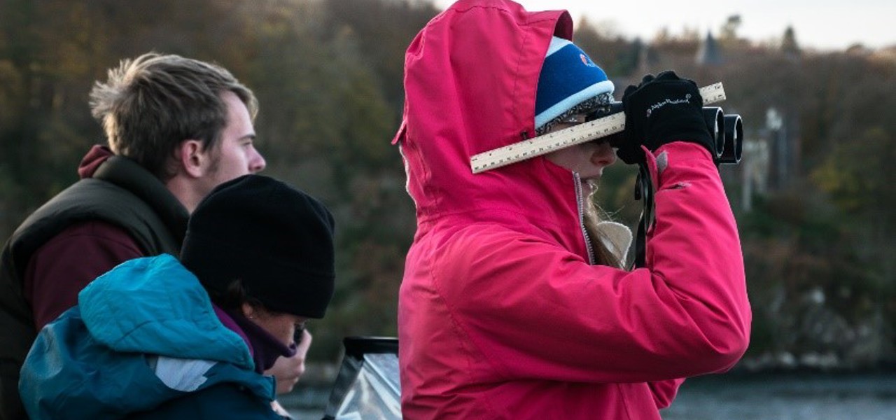 Volunteer Seabirds at Sea volunteer using binoculars