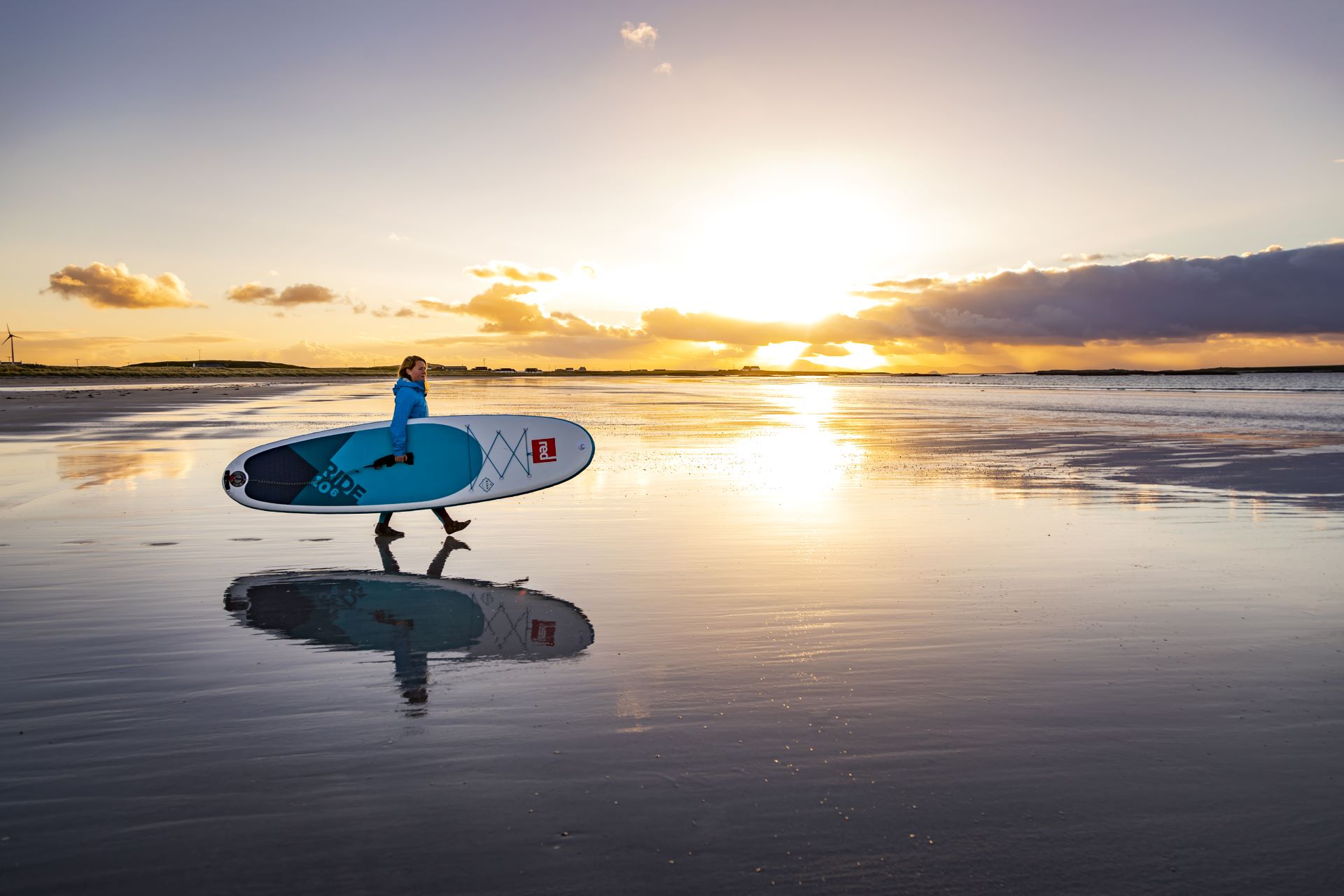 A Stand up paddle boarder on the beach at sunset, Tiree