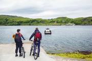 Father and on bikes at the slipway waiting for the ferry to arrive