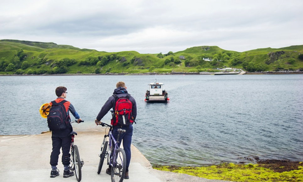 Father and on bikes at the slipway waiting for the ferry to arrive