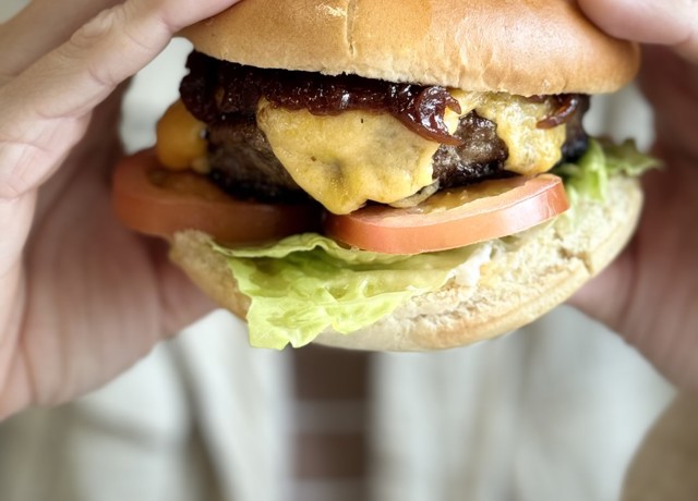 Close up of a burger being held by two hands