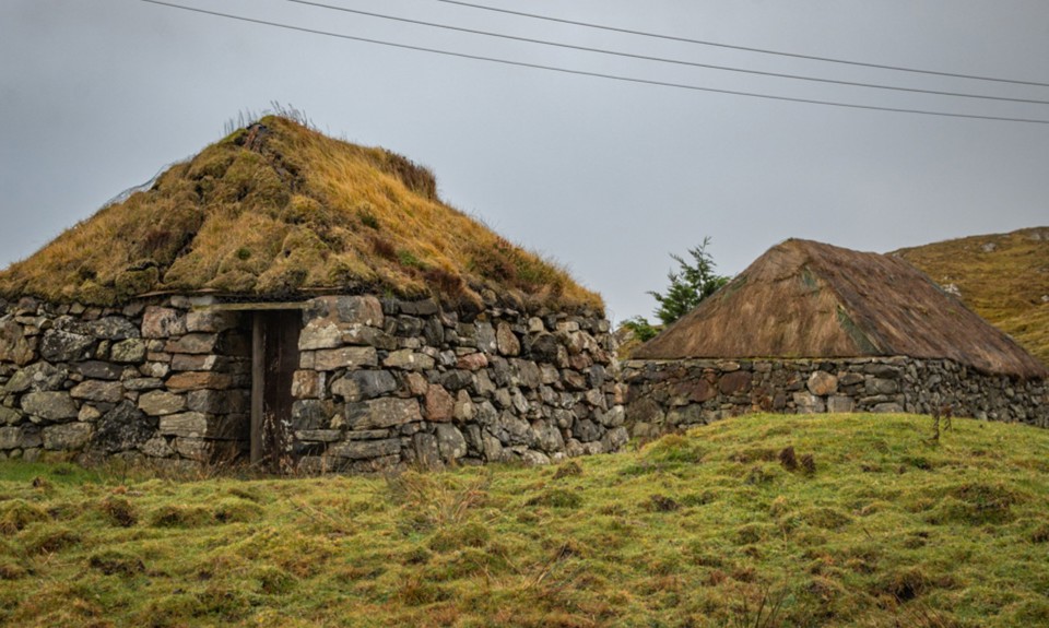  Turf roofed buildings at Sorisdale on The Isle of Coll located on a grass embankment