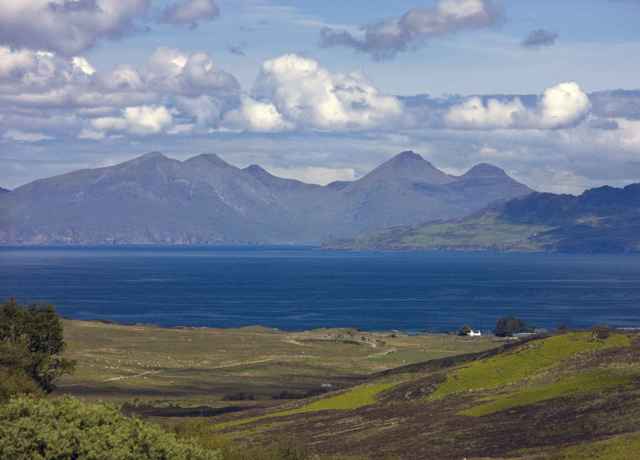 A view across the water to the mountainous island of Rum from Ardnamurchan peninsula.