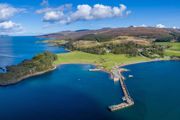 An aerial view of Clachan, Isle of Raasay. A view of the pier, coastline and hillside of Raasay.