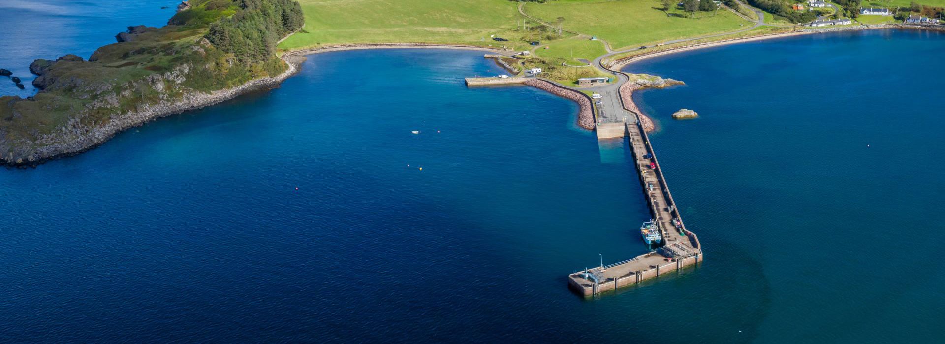 An aerial view of Clachan, Isle of Raasay. A view of the pier, coastline and hillside of Raasay.