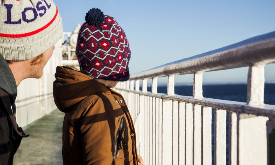 little boy and his dad out of deck looking out to sea