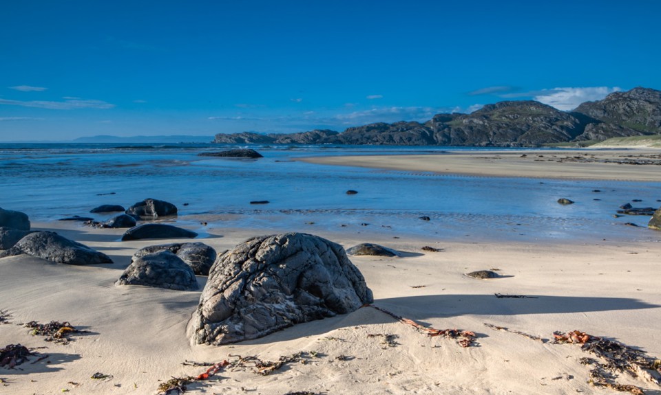sandy beach with large rocks on the sand