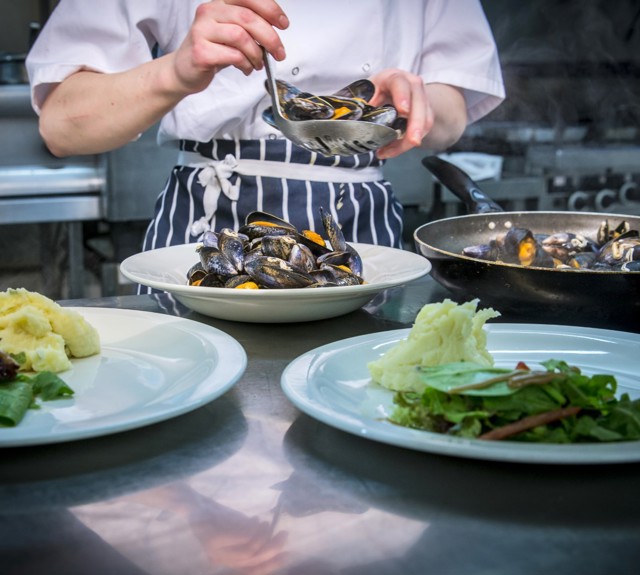 Chef preparing three meals in the kitchen