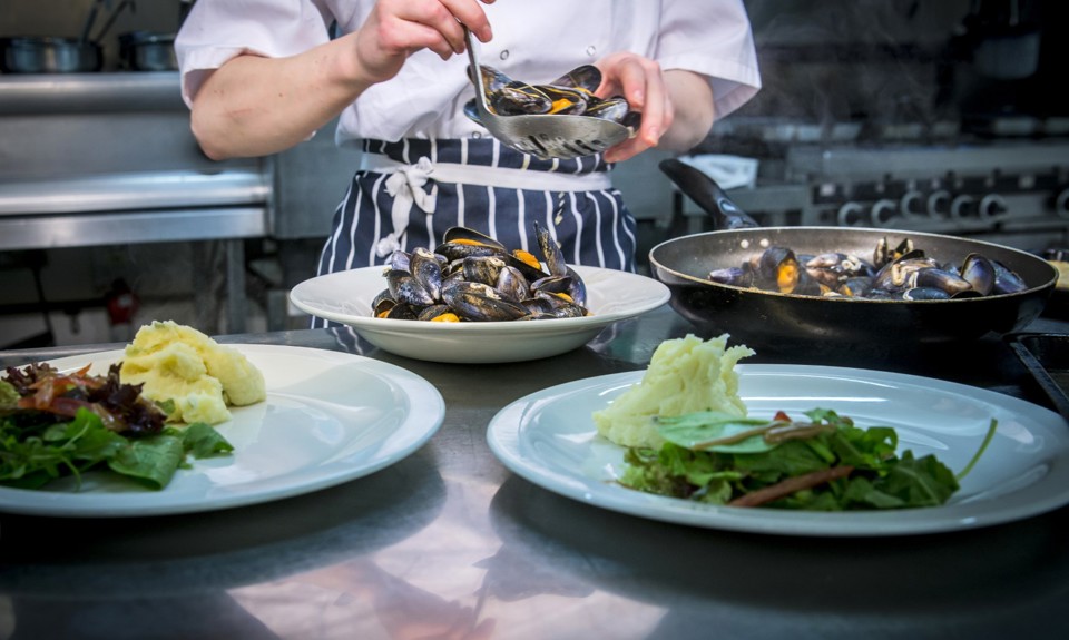 Chef preparing three meals in the kitchen