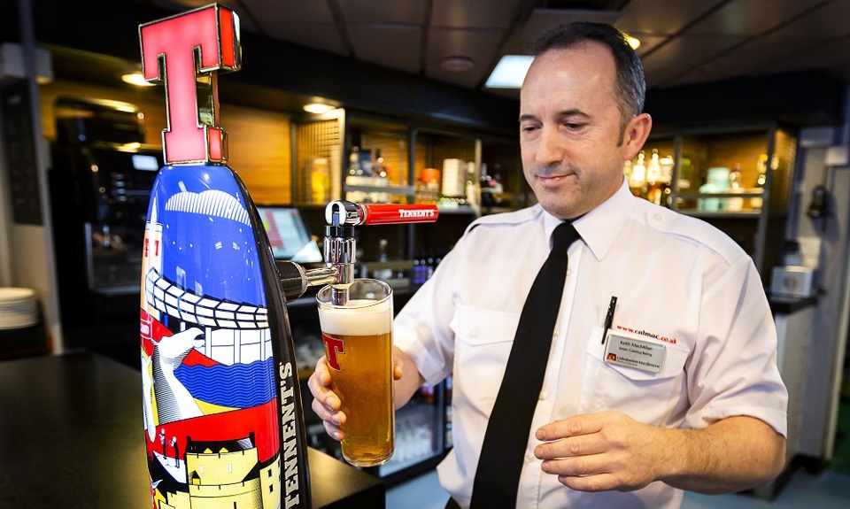 staff pouring a pint of lager