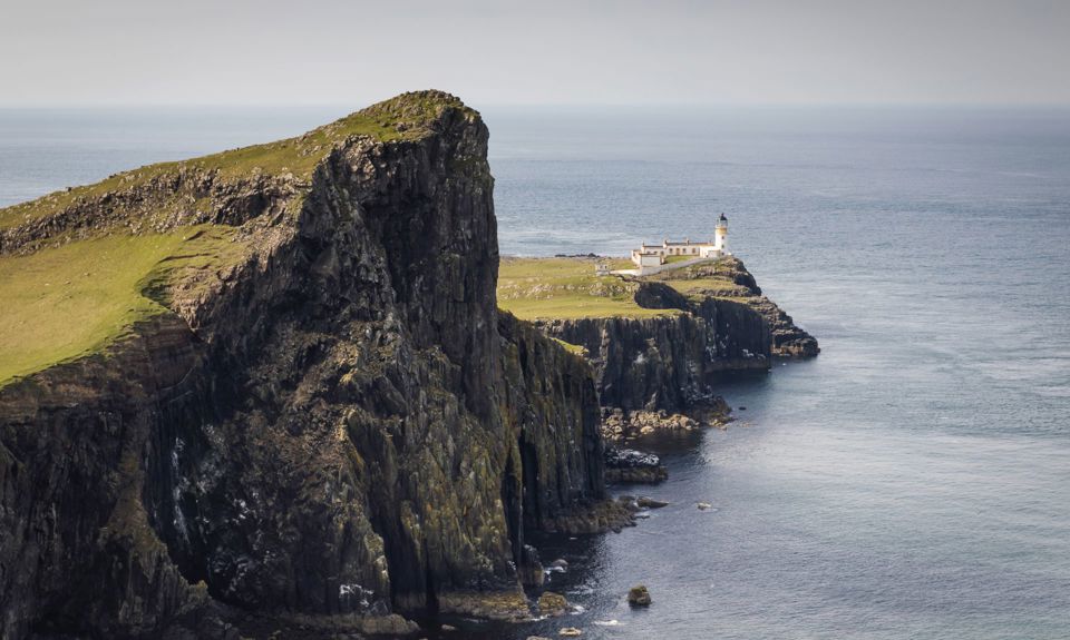 Rocky landscape and coastline with Neist Point Lighthouse sitting proudly at the end.