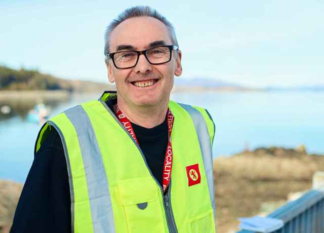 Gary, Port assistant at CalMac at the port in his high visibility workwear.